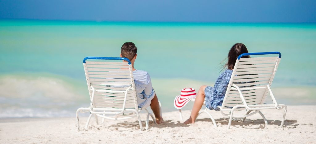 Couple relaxing on a tropical beach at Maldives